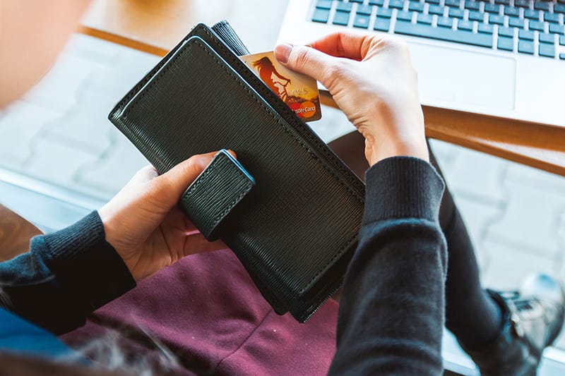pulling out a credit card from wallet