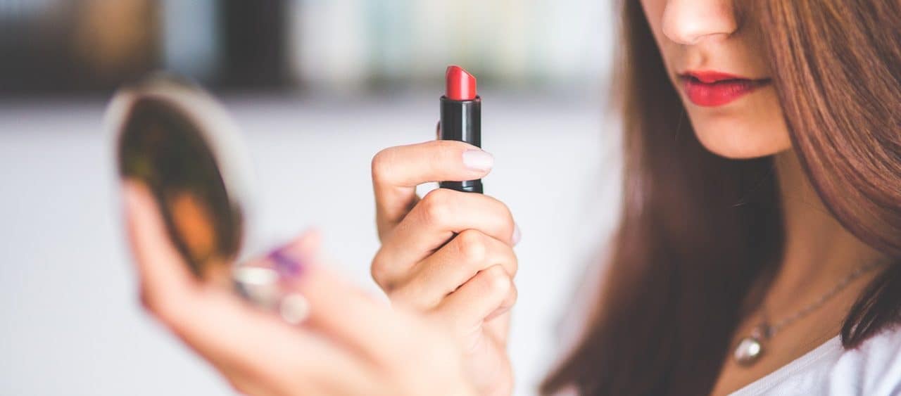lady applying lipstick
